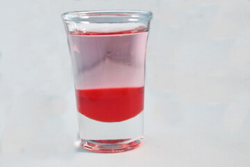 red drink in a small glass that is fresh when drunk, if sold