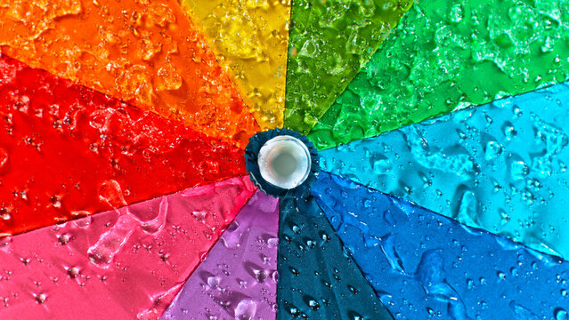 Rain drops on colored umbrella, freeze motion
