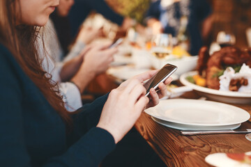 Closeup, woman and phone chatting at dinner on social media, web or app for communication at party....