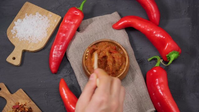 Ajvar from sweet peppers, eggplant, tomatoes, garlic and onions with spices wooden table. Balkan food. Selective focus