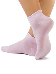 Side view of beautiful woman foot dressed in new nice and soft natural cotton fabric blank pink socks