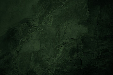 Dark green old cracked concrete wall. Rough texture background for design. Distressed. Close-up.
