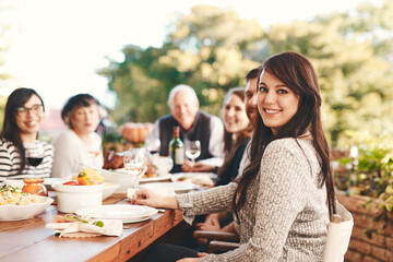 Happy woman, family and food outdoor at patio table for thanksgiving or Christmas celebration wine,...
