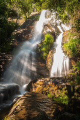 Fototapeta premium Beautiful water stream in Filveda waterfall, Sever do Vouga, Portugal. Long exposure smooth effect. Idyllic green scenery, mountain forest landscape.