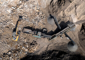 Concrete Recycling and asphalt from demolition. Excavator at landfill the load concrete waste in a...