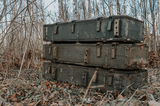 Weapon box. Box with weapons and ammunition in the forest. Old wooden weapons boxes left after the war in the forest. Military ammunition and weapon. Army ammunition for of the armed forces