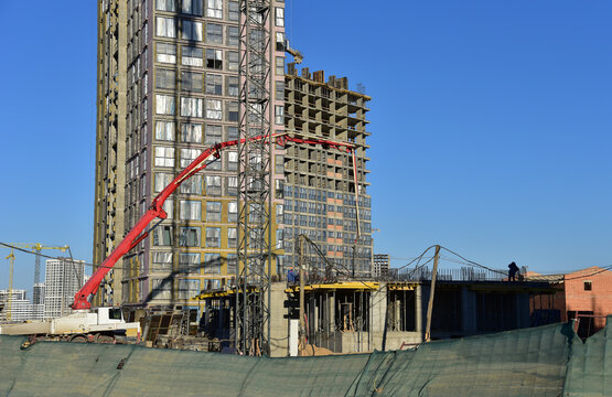 Concrete Pump Machinery on Formwork. Pouring concrete from mixer truck. Truck Mounted Concrete Pump on formwork during construction. Crane on Large construction project. Construction site with crane..