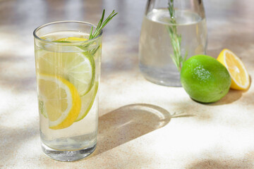 Tasty refreshing lemonade and ingredients on light table, space for text. Summer drink