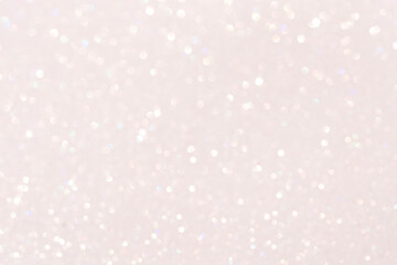 Glamorous sparkling defocused blurred festive background in light pink tones.