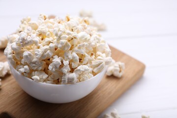Tasty popcorn on white wooden table, closeup