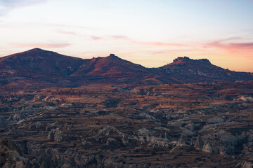Stunning view of some rock formations in the Red & Rose Valley in Cappadocia during a beautiful sunrise. Goreme, central Antolia, Turkey.