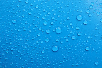 Naklejka na ściany i meble Water drops on light blue background, top view