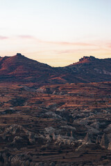 Stunning view of some rock formations in the Red & Rose Valley in Cappadocia during a beautiful sunrise. Goreme, central Antolia, Turkey.
