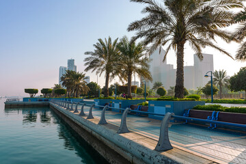 Abu Dhabi Skyline from Corniche. Abu Dhabi, Modern Skyscrapers and Landmark.Promenade in Abu Dhabi. United Arab Emirates, Middle East. 