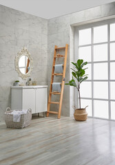 Modern bath room corner, white cabinet and sink, mirror and decorative objects.