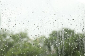 Window glass with raindrops as background, closeup