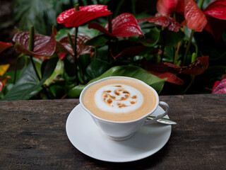 Cappuccino coffee in a white cup on the table