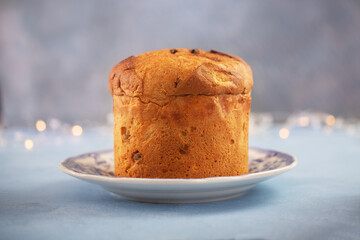 One panettone sweet bread , traditional Italian food for Christmas on a blue background