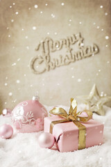 Obraz na płótnie Canvas Christmas gift and ornaments in the snow
