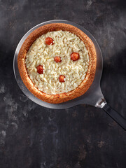 pizza with cheese and tomato on shovel