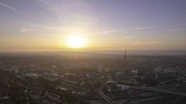 Ulm city center and minster after colorful sunrise with some fog aerial time lapse