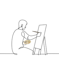 man sitting in front of an easel holding a palette and painting on canvas with a brush - one line drawing vector. concept of a male artist in the process of drawing a picture; art therapy; art school