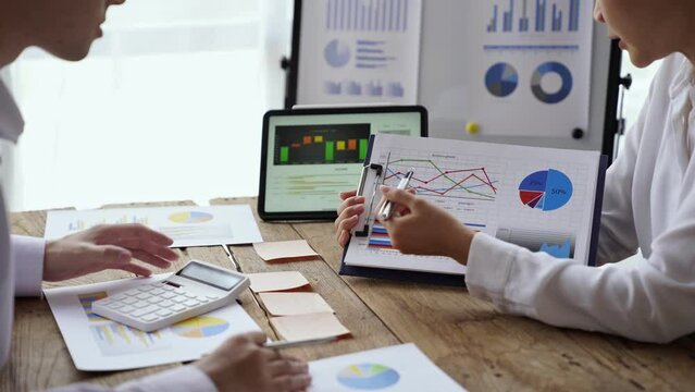 Brainstorm team, Marketers and financial accountants are discussing and analyzing charts to plan strategies to meet customer needs, Business data graph, Team meetings or business consulting.