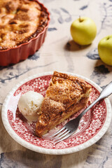 Classic American apple pie served with ice cream on linen tablecloth. Homemade american autumn dessert: sliced apple pie (tart) with cinnamon. Selective focus - 548730114