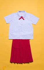 asian school uniform with red skirt on yellow background.