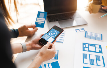 Working at desk, start up, UX team works from a single location under a UX leader and UX managers, UX design involves a great amount of teamwork.