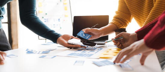 Working at desk, start up, UX team works from a single location under a UX leader and UX managers, UX design involves a great amount of teamwork.