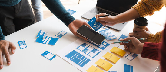 Working at desk, start up, UX team works from a single location under a UX leader and UX managers, UX design involves a great amount of teamwork.