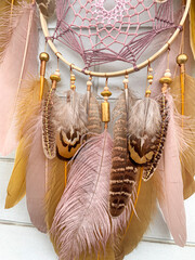 Close up pheasant feathers dream catcher bohemian wall hanging craft outdoors