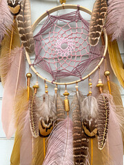 Close up pheasant feathers dream catcher bohemian wall hanging craft outdoors
