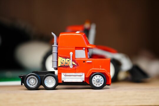 Selective focus closeup view of a toy model Mack truck from the Disney Pixar Cars series.
