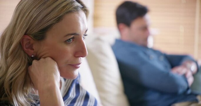 Couple fight, ignore partner and and divorce on lounge sofa, anxiety and marriage stress, toxic relationship crisis and conflict. Frustrated woman, sad man and counseling therapy for cheating problem