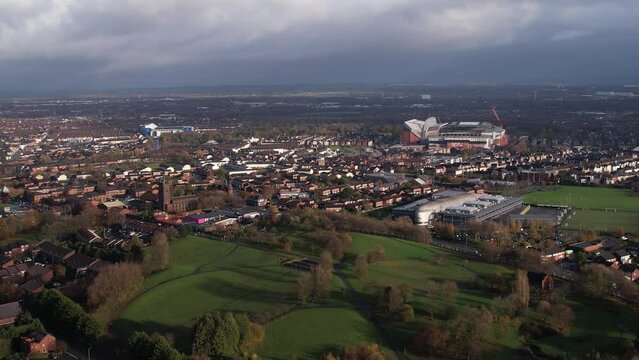 Aerial view tracking left of Anfield and Goodison Park Stadiums amongst the suburbs of Liverpool 