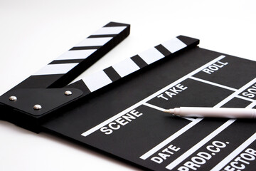 Fototapeta na wymiar Clapperboard or movie slate black color and marker pen on white background. Cinema industry, video production and film concept.