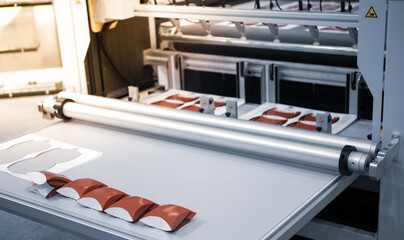 Digital cutting machine. Food folding packaging process on digital cutting machine. Printing...