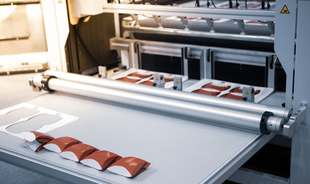 Digital cutting machine. Food folding packaging process on digital cutting machine. Printing industry.