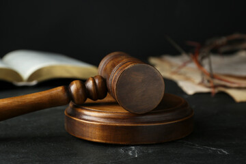 Wooden judge gavel on black table, closeup