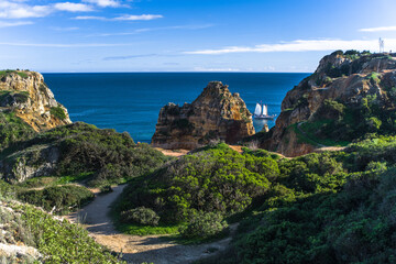Rock cliffs, inselbergs, beach, rock formations. Cabo de Sao Vicente. Sagres. View of beaches, cliffs and ocean. Algarve. Daylight, horizontal