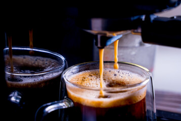 close-up of Coffee foam. espresso crema comes out of the fully automatic coffee machine, Making the coffee machine into a cup. soft focus.