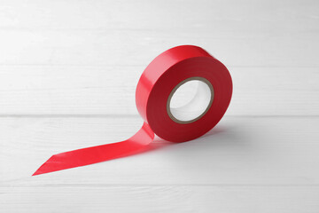 Red insulating tape on white wooden table