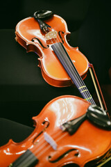 Fototapeta premium Two violins on some chairs