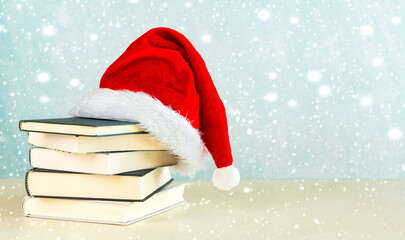 Merry Christmas. Santa's hat with books and snowflakes with space for text. Christmas concept...