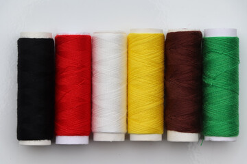 Equipment and sewing threads on white background