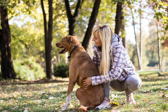 Young woman embracing her dog