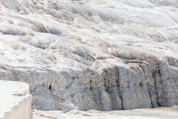 Fototapeta na wymiar White volcanic limestone rock as background.
