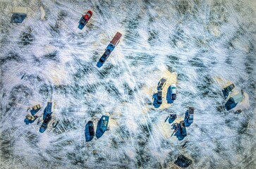 Aerial view of cars and moveable huts placed on a frozen lake